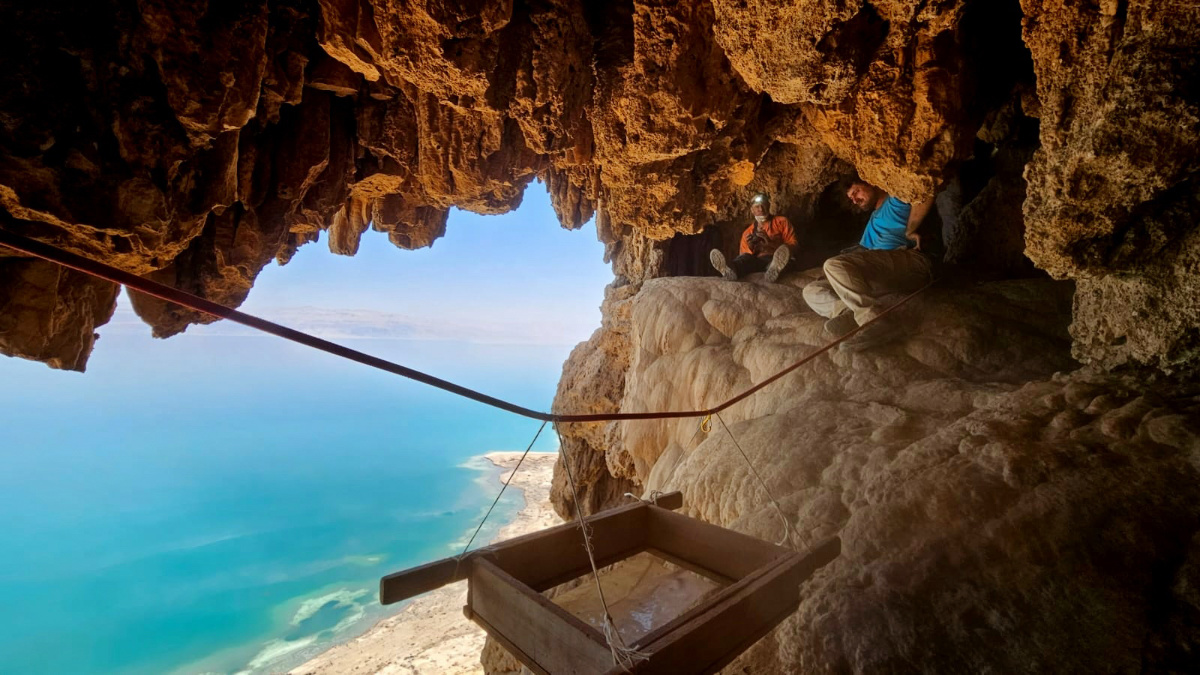 Archaeologists work in a cave above the Dead Sea in eastern Israel in August, 2023. 