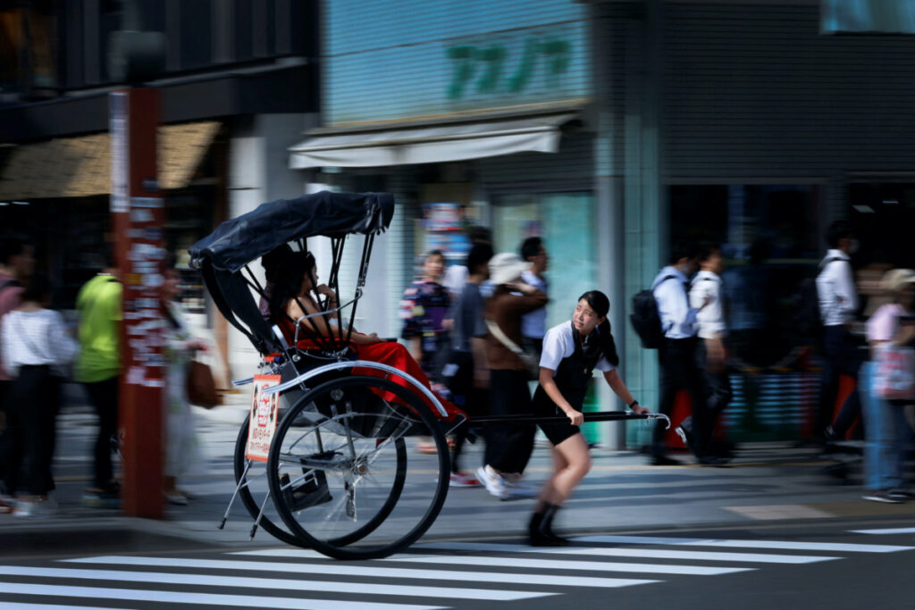 Rickshaw puller Akina Suzuki, 19, drives a rickshaw around Asakusa district in Tokyo, Japan, on 18th June, 2023.