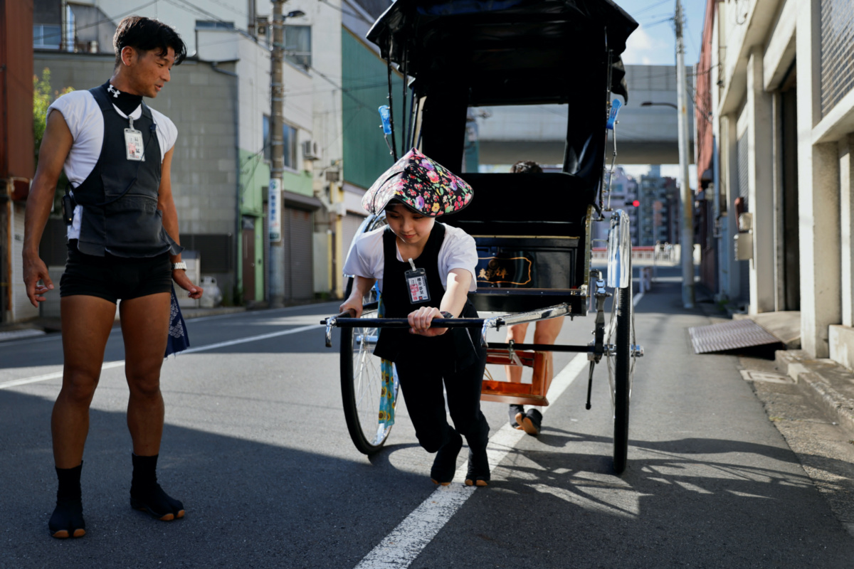 Trainee Yumeka Sakurai, 20, receives rickshaw driving lessons from her colleagues in the Asakusa district, Tokyo, Japan, on 17th August, 2023