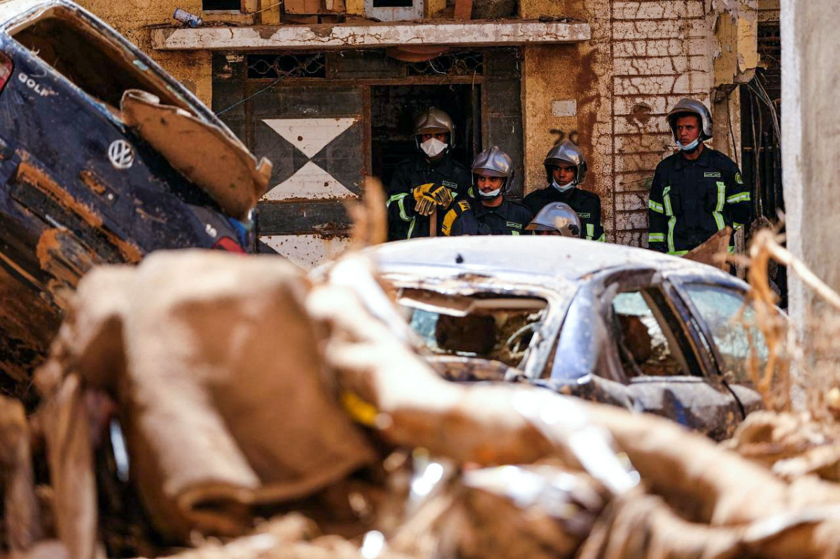 Members of the rescue team from the Egyptian army look at damaged cars in Derna, Libya, following a powerful storm and heavy rainfall, on 13th September, 2023.