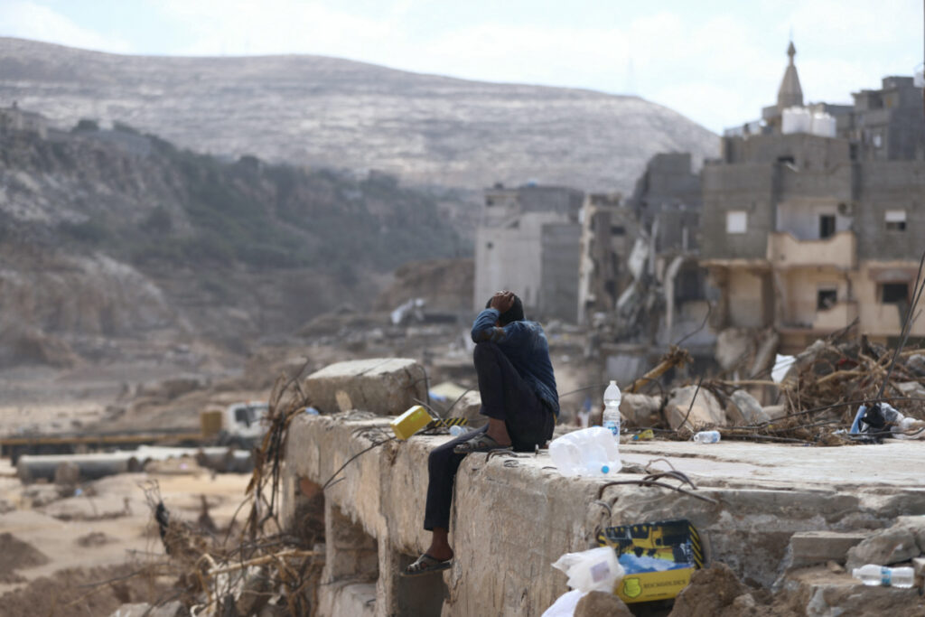A man sits on rubble caused by fatal floods in Derna, Libya, on 18th September, 2023