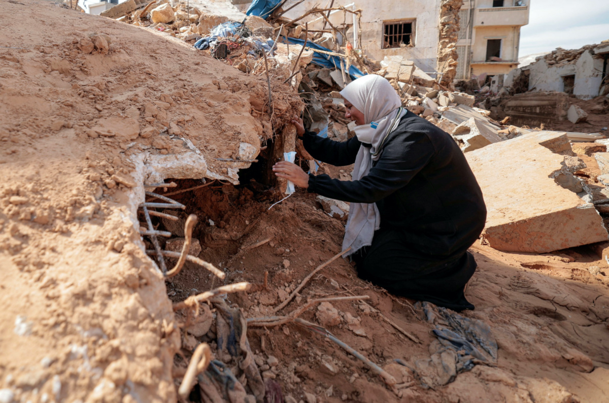 Sabrine Ferhat Bellil, who said she lost her brother, his wife and 5 of his children when the deadly storm hit her city, reacts amid rubble beside her brother's destroyed house, where she is hoping to find their bodies to bury, in Derna, Libya, on 17th September, 2023.