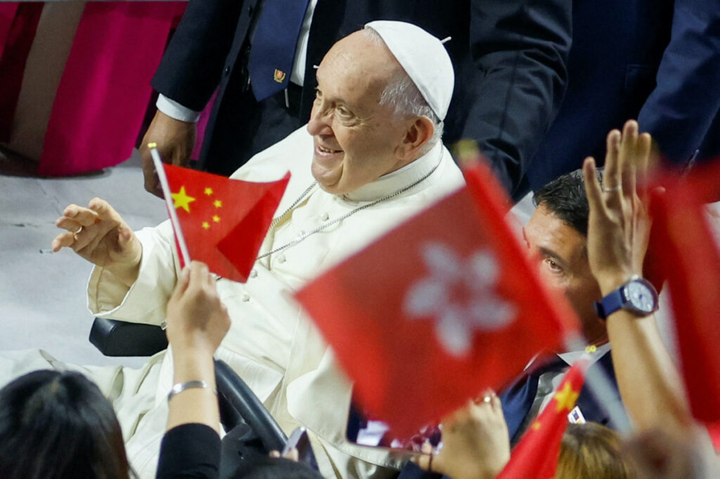 People wave Chinese and Hong Kong flags, as Pope Francis arrives to attend the Holy Mass in the Steppe Arena, during his Apostolic Journey in Ulaanbaatar, Mongolia, on 3rd September, 2023.