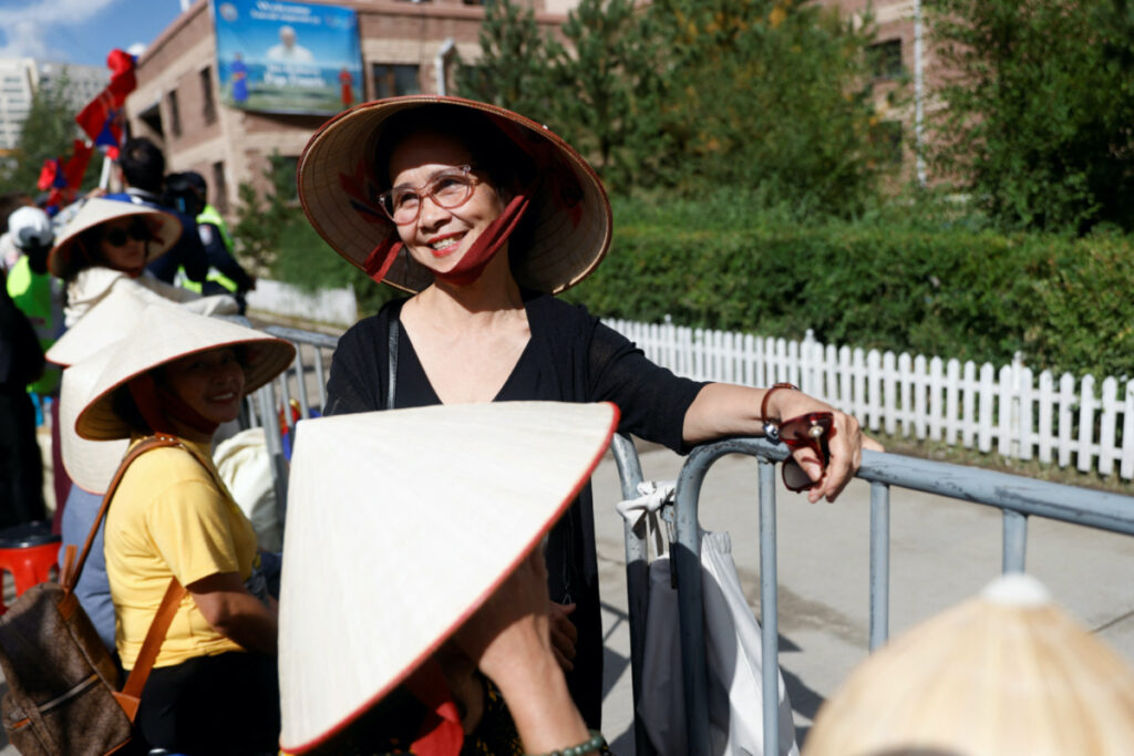 Mai Anh from Vietnam waits outside Saints Peter and Paul Cathedral on the day Pope Francis meets with bishops, priests, missionaries, consecrated persons and pastoral workers at the cathedral, during his Apostolic Journey in Ulaanbaatar, Mongolia, on 2nd September, 2023
