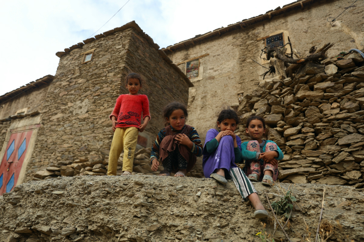 Children affected by a deadly earthquake stand outside a house, in the rural village of Azermoun, Morocco on 14th September, 2023