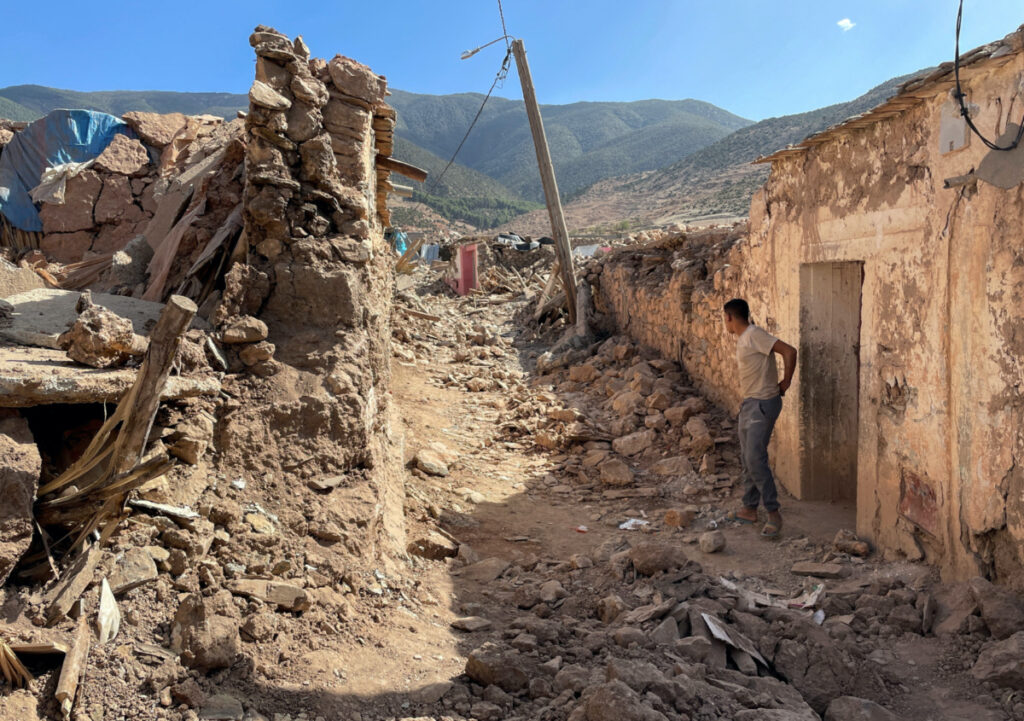 A person stands near damaged houses in Tafeghaghte, a remote village of the High Atlas mountains, following a powerful earthquake in Morocco, on 10th September, 2023