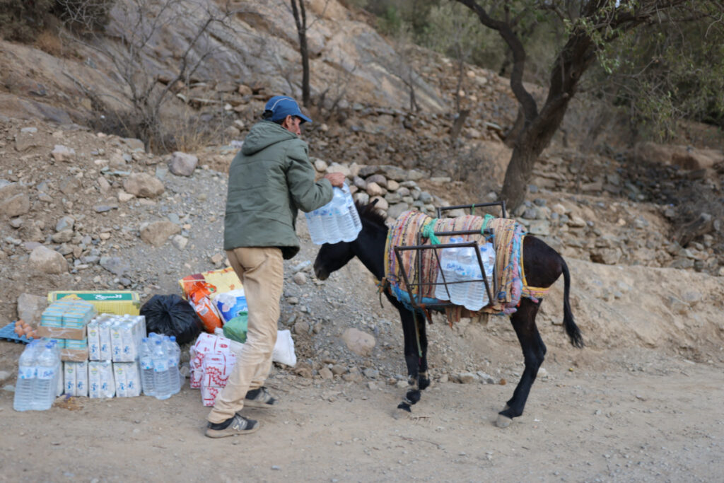 A man packs bottles of water on his donkey after receiving donations, in the aftermath of a deadly earthquake, near Talat N'Yaaqoub, in Morocco, on 12th September, 2023.