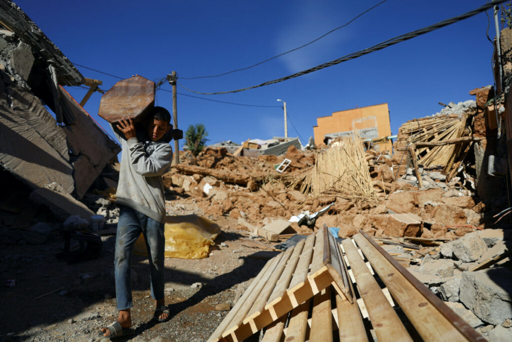 A person carries an item of furniture, in the aftermath of a deadly earthquake, in a hamlet on the outskirts of Talat N'Yaaqoub, Morocco, on 11th September, 2023