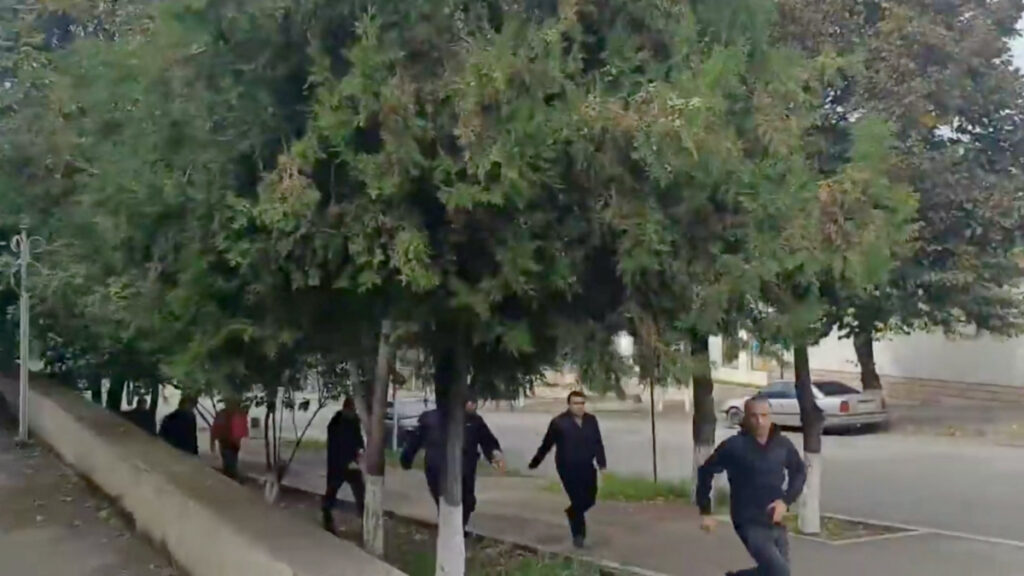 People run as gunfire and explosions are heard in Stepanakert, called Khankendi by Azerbaijan, in the Nagorno-Karabakh region, on 19th September, 2023, in this screengrab obtained from a handout video.