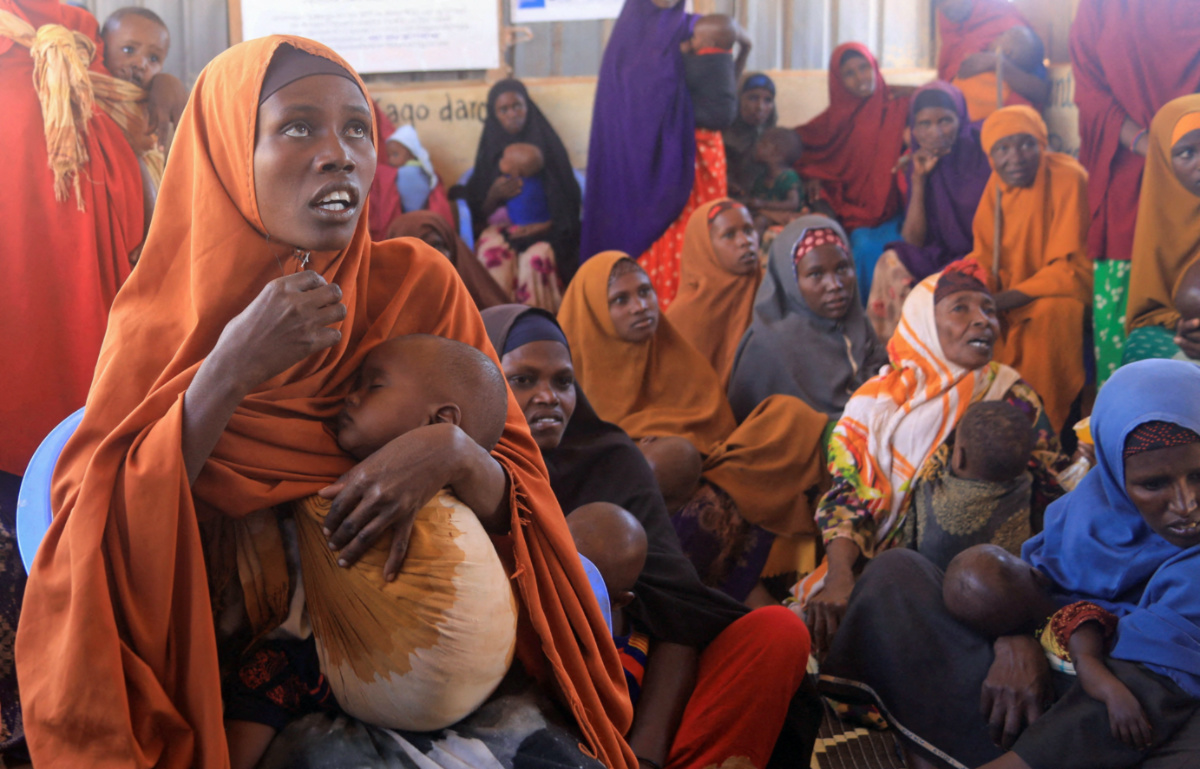 Fadumo Isaq Abdi, an internally displaced Somali woman, holds her child Maria Mohamed Ali at the feeding centre, a new site for IDPs, in Barwaaqo, near Baidoa, Somalia, on 21st February, 2023