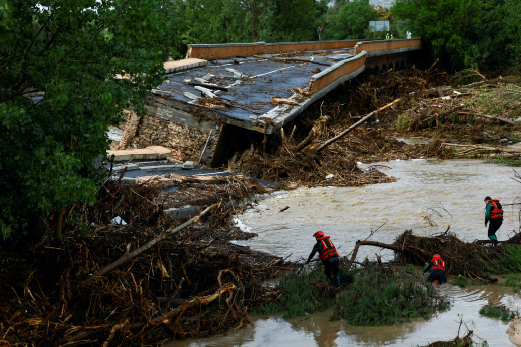 Members of the Spanish Civil Guard search and rescue team look for a missing person by a bridge that partially collapsed, following heavy rain in Aldea del Fresno, Spain, on 4th September, 2023