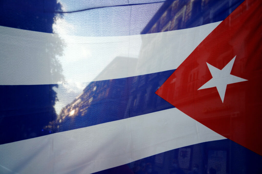 The silhouette of the city is seen through a Cuban flag during a protest against the US economic embargo in Cuba, in Madrid, Spain, on 26th July, 2021