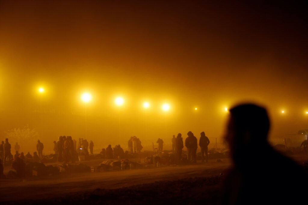 Migrants stand near the border wall during a sandstorm after having crossed the US-Mexico border to turn themselves in to US Border Patrol agents, as the US prepares to lift COVID-19 era Title 42 restrictions that have blocked migrants at the border from seeking asylum since 2020, in El Paso, Texas, US, on 10th May, 2023