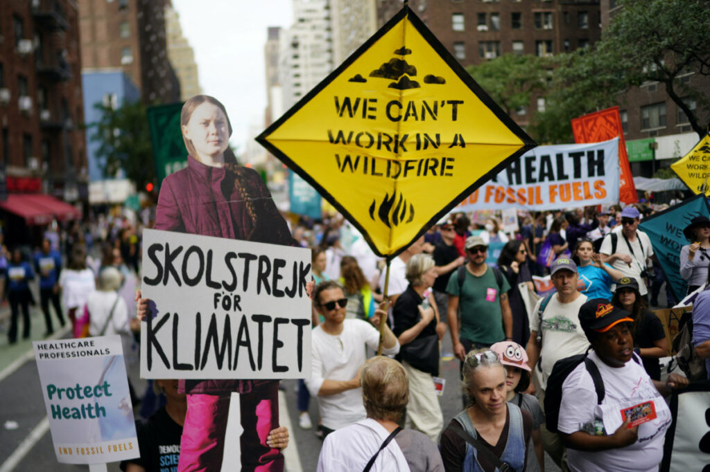 A person holds a cutout of Climate activist Greta Thunberg as activists mark the start of Climate Week in New York during a demonstration calling for the US Government to take action on climate change and reject the use of fossil fuels in New York City, New York, US, on 17th September, 2023