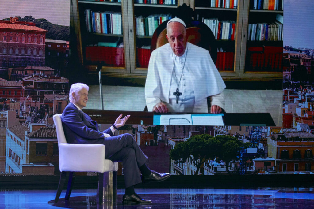 Former President Bill Clinton, left, speaks with Pope Francis, on screen, via video during the Clinton Global Initiative, on Monday, 18th September, 2023 in New York