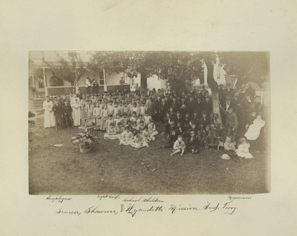 In this photo taken between 1869 and 1895, provided by the Quaker and Special Collections at Haverford College, school children of the Seneca, Shawnee, and Wyandotte Mission Indian Territory, gather for a portrait in Wyandotte, Oklahoma