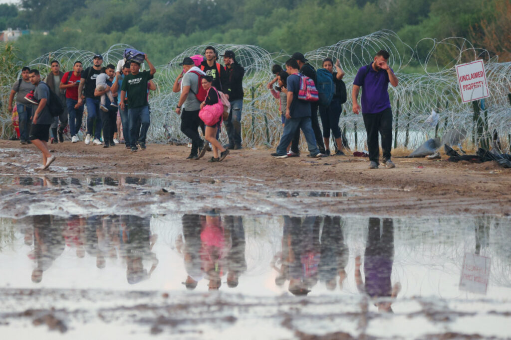 Migrants from Venezuela walk as they surrender to authorities in Eagle Pass, Texas, US, on 26th September, 2023