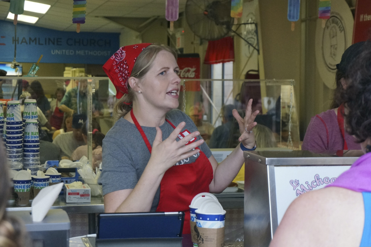 Rev Mariah Furness Tollgaard of Hamline Church works at the to-go counter at the Methodist church's dining hall during the Minnesota State Fair in Falcon Heights, Minnesota, on Thursday, 24th August, 2023.