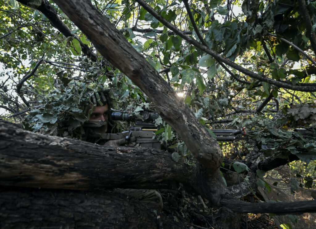 A sniper of Ukraine's 3rd Separate Assault Brigade takes a position during a reconnaissance mission, amid Russia's attack on Ukraine, near Bakhmut, Ukraine, on 7th September, 2023