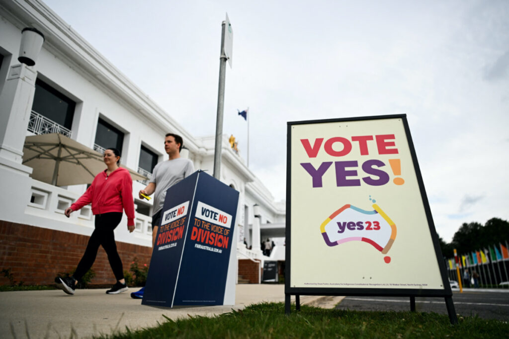Voters walk past Vote 'Yes' and Vote 'No' signs at the Old Australian Parliament House, during The Voice referendum in Canberra, Australia, on 14th October, 2023
