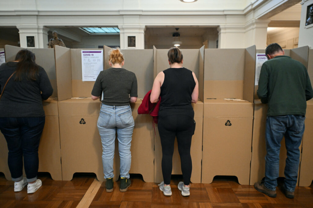 Voters are seen at the ballot box at the Old Australian Parliament House, during The Voice referendum in Canberra, Australia, on 14th October, 2023
