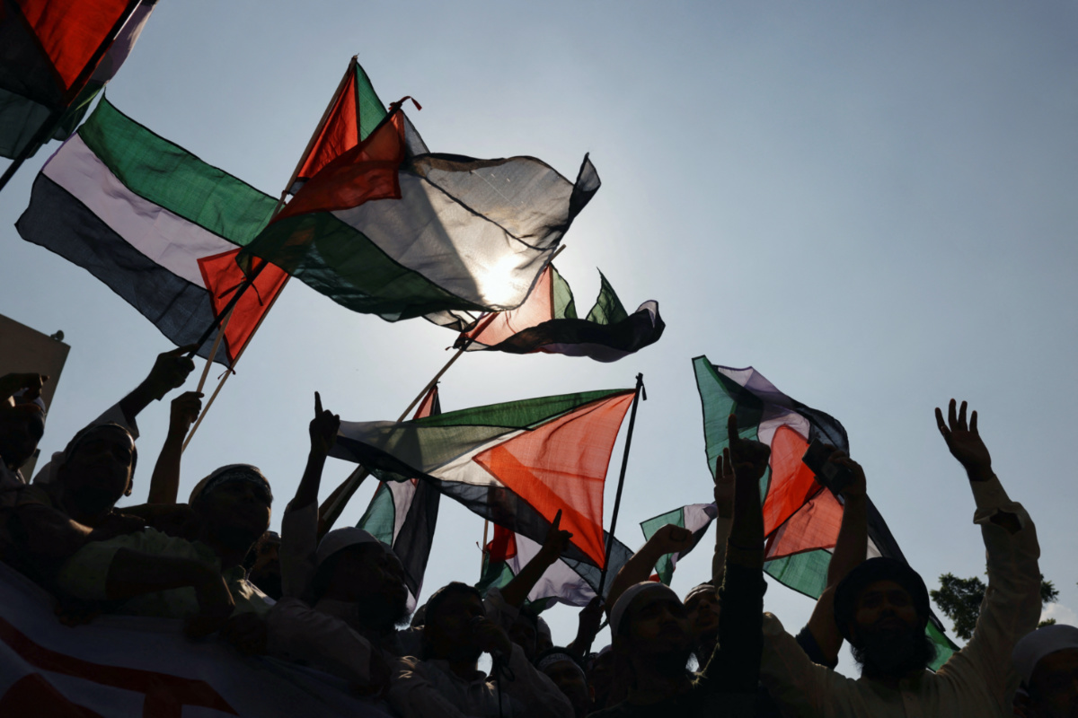 Bangladeshi Muslim activists wave Palestinian flags as they protest against Israel's actions against Palestinians after Friday prayer at the Baitul Mukarram National Mosque in Dhaka, Bangladesh, on 13th October, 2023.