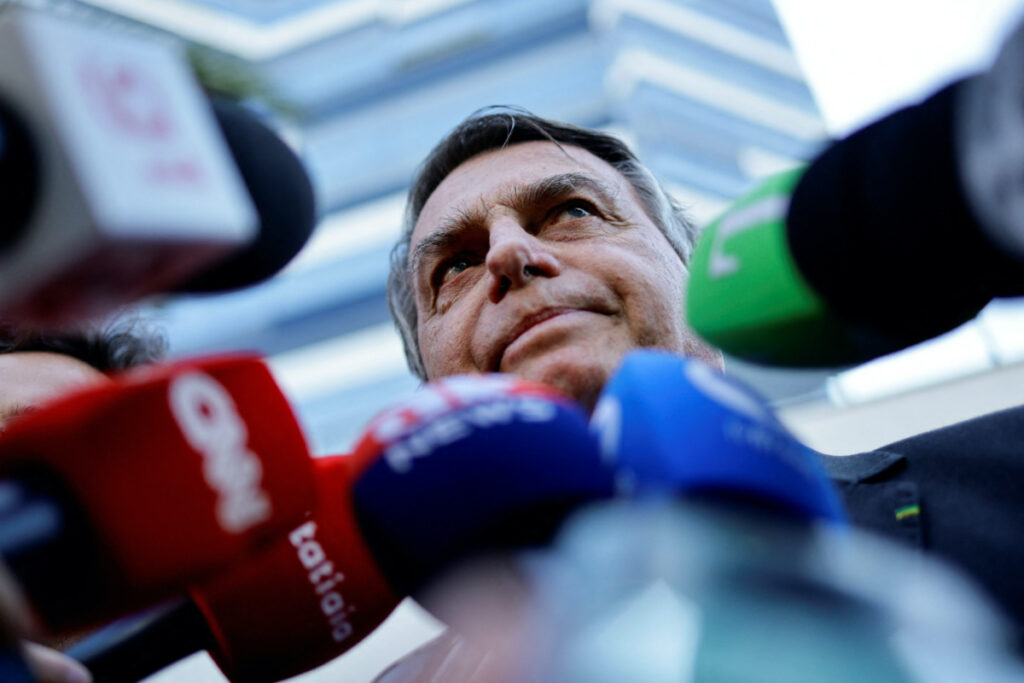 Former Brazilian President Jair Bolsonaro speaks with the media as he leaves the Federal Police headquarters after testifying about the 8th January riots, in Brasilia, Brazil, on 18th October, 2023
