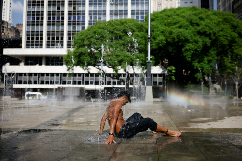 Homeless Danilo da Silva uses a fountain to cool off and wash himself, during a heatwave in the Anhangabau Valley, in the centre of Sao Paulo, Brazil, on 22nd September, 2023