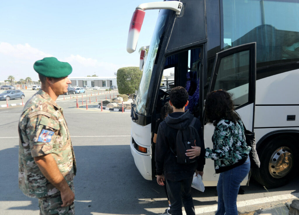 People who were evacuated from Israel, board a bus after arriving at the Larnaca International Airport, in Larnaca, Cyprus, on 11th October, 2023.