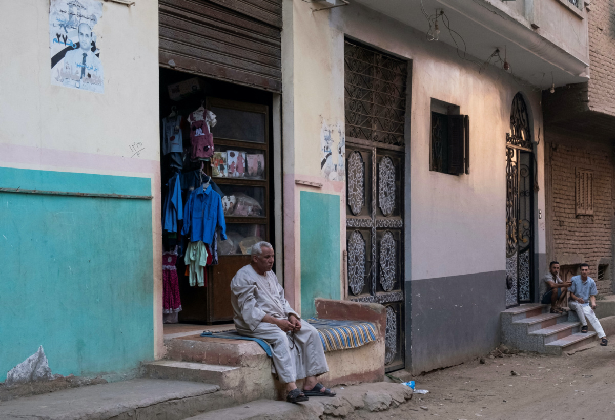 A man sits in front of his shop waiting for customers at Mit Suhayl village, the hometown of several Egyptian migrants who died after a boat capsized close to Greece shores in June, Sharqia governorate, Egypt, on 17th August, 2023