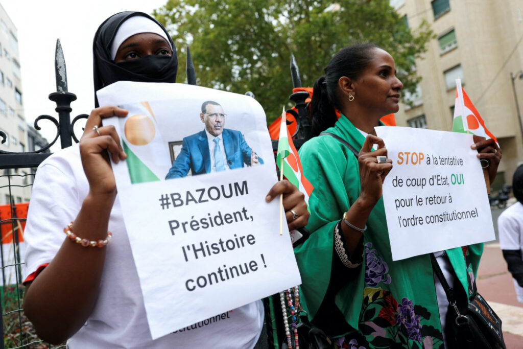 Demonstrators hold placards and Niger's flags as they gather outside Niger's embassy in support of the President of Niger Mohamed Bazoum in Paris, France, on 5th August, 2023