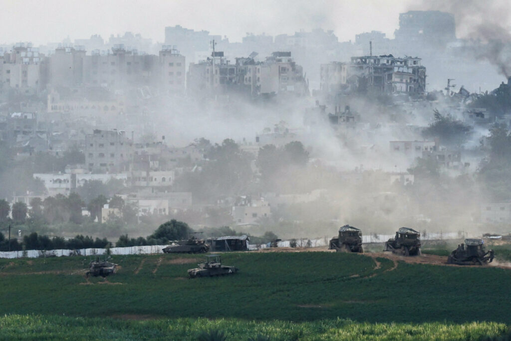 Israeli tanks and other military vehicles manoeuvre inside the Gaza Strip, as seen from Israel, on 29th October, 2023
