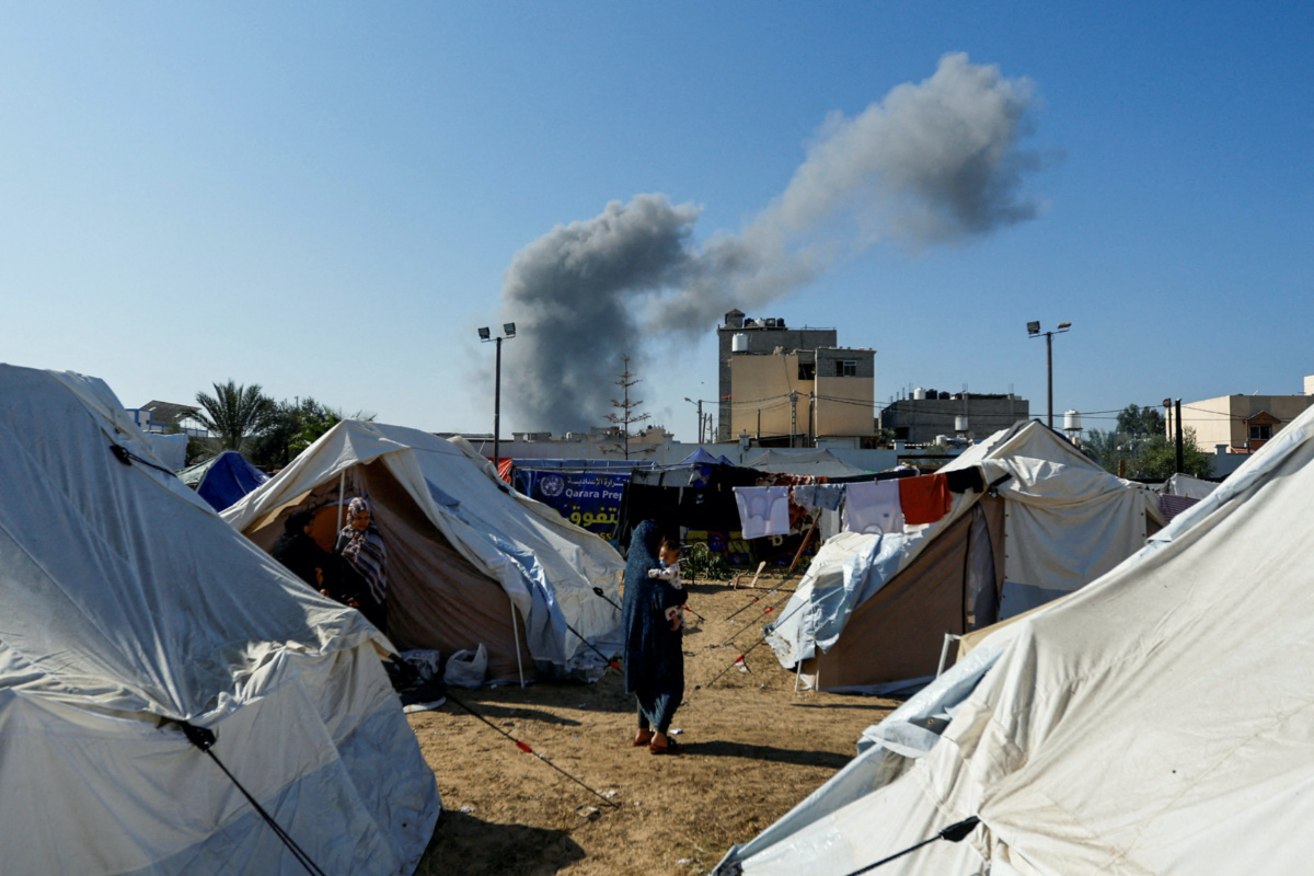 Smoke rises from nearby Israeli strikes as seen from a tent camp sheltering displaced Palestinians, as the conflict between Israel and Palestinian Islamist group Hamas continues, in Khan Younis in the southern Gaza Strip, on 26th October, 2023