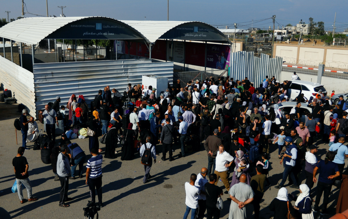Palestinians with dual citizenship gather outside Rafah border crossing with Egypt in the hope of getting permission to leave Gaza, amid the ongoing Israeli-Palestinian conflict, in Rafah in the southern Gaza Strip, on 16th October, 2023