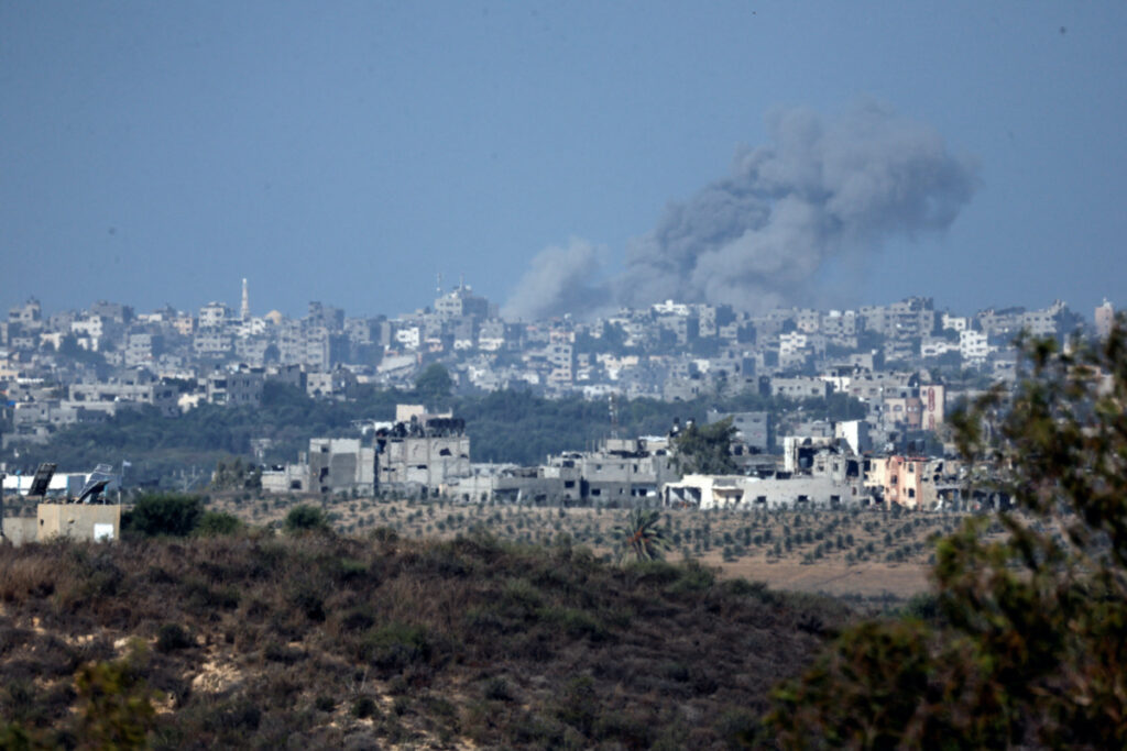 A view shows smoke in the sky and destroyed buildings in the Gaza Strip as seen from Israel's border with the Gaza Strip, in southern Israel, on 15th October, 2023