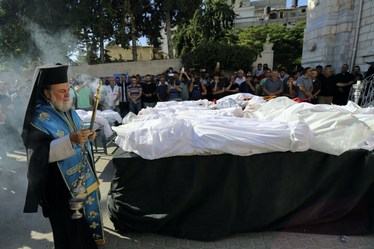 Greek Orthodox Archbishop Alexios holds a funeral prayer for Palestinians who were killed in Israeli airstrikes that hit a Greek Orthodox church, in Gaza City, on Friday, 20th October, 2023