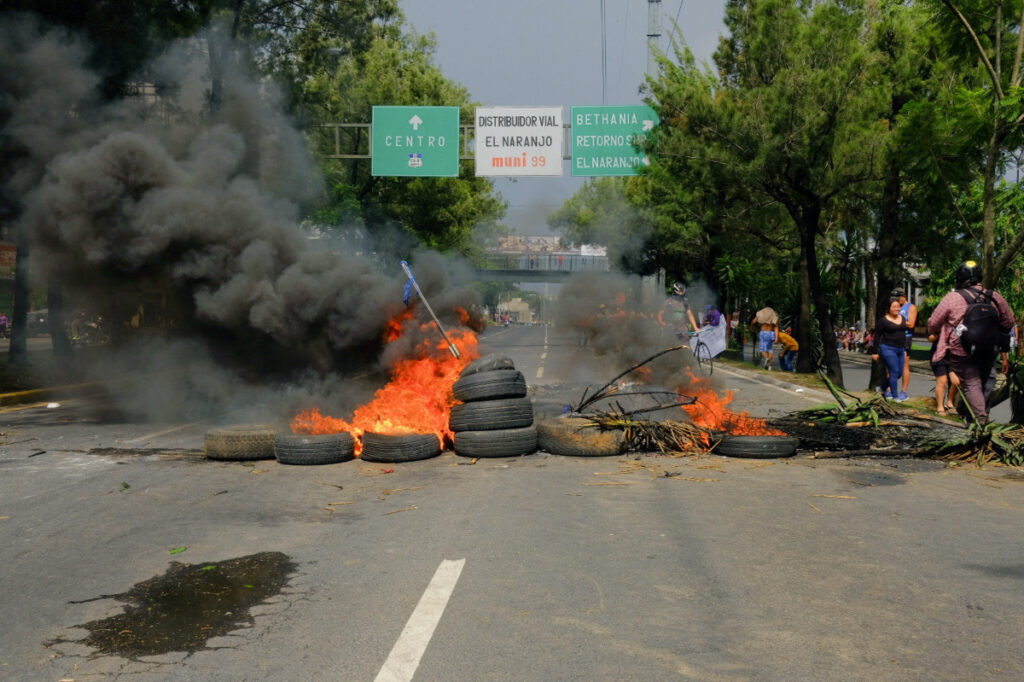 A burning barricade is pictured as demonstrators block an avenue as part of a national strike to demand the resignation of authorities from the attorney general's office, in Guatemala City, Guatemala, on 10th October, 2023.