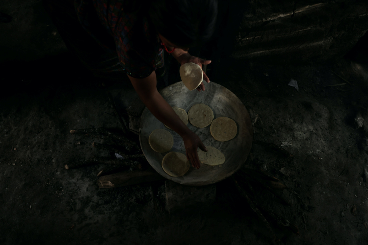 Maria Concepcion Rodriguez, 30, the mother of six children, cooks corn tortillas for lunch at her house in El Aguacate village in Baja Verapaz, Guatemala, on 16th August, 2023.