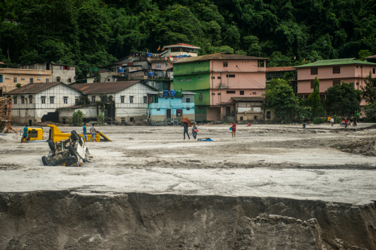 People walk along the area affected by the flood at Golitar, in Singtam, Sikkim, India, on 5th October, 2023