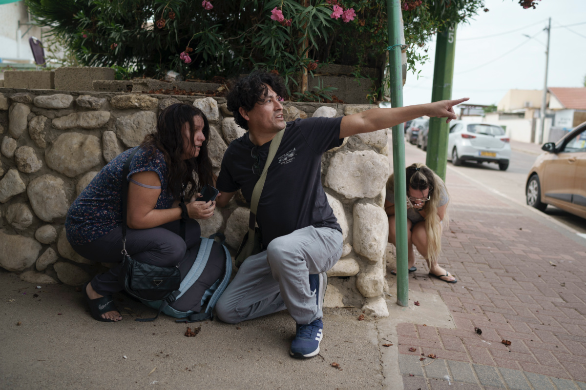 Israelis take cover from the incoming rocket fire from the Gaza Strip in Ashkelon, southern Israel, on Wednesday, 11th October, 2023