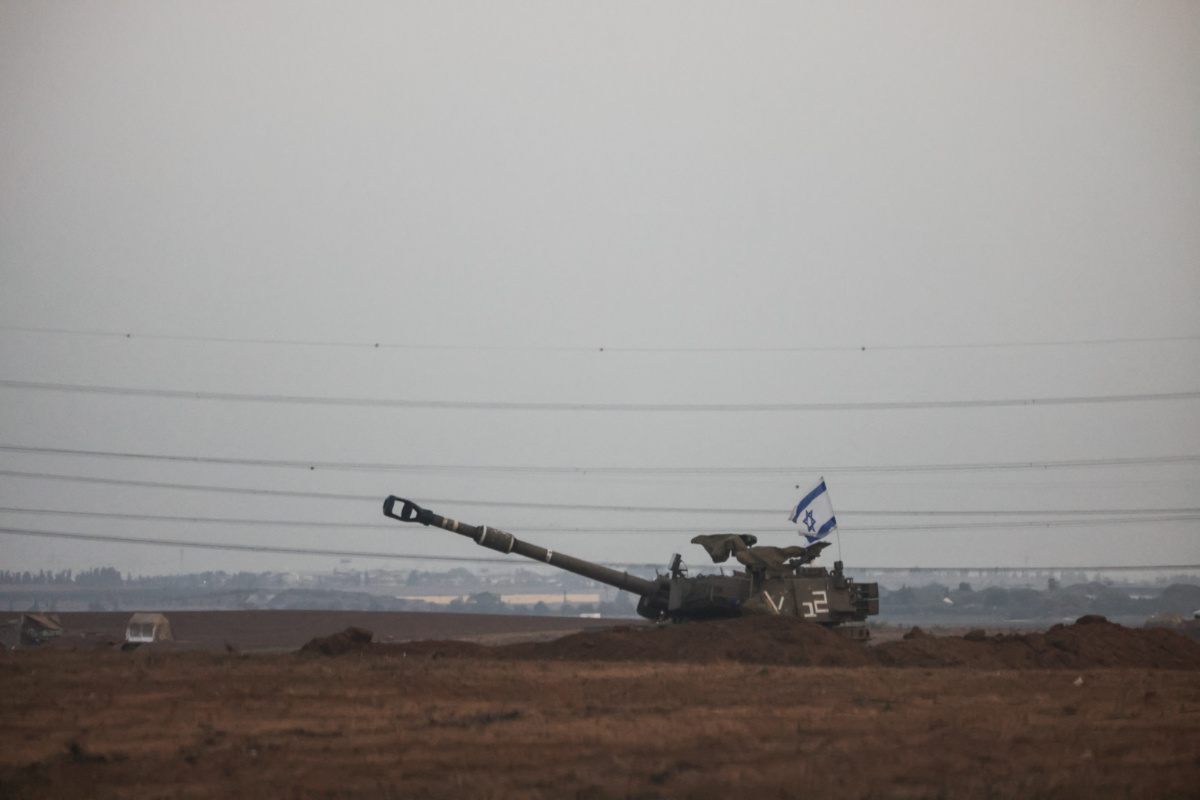 An Israeli flag flutters from a self-propelled howitzer near Israel's border with the Gaza Strip, in southern Israel, on 22nd October, 2023