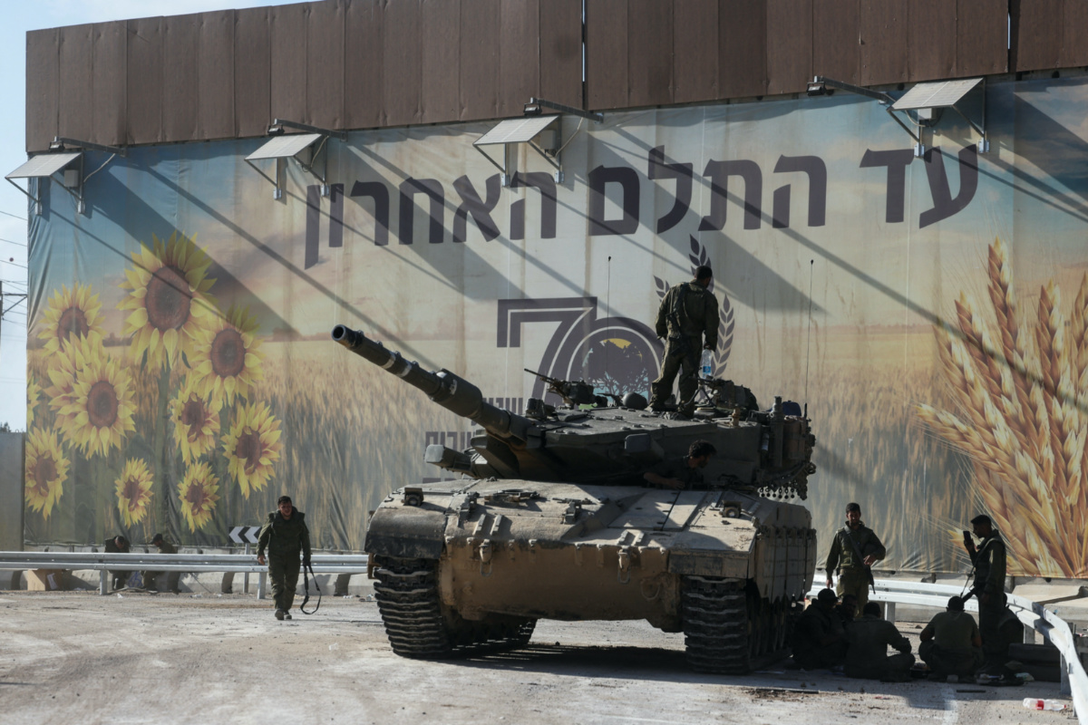 Israeli soldiers gather on and around a tank near Israel's border with the Gaza Strip, in southern Israel on 15th October, 2023