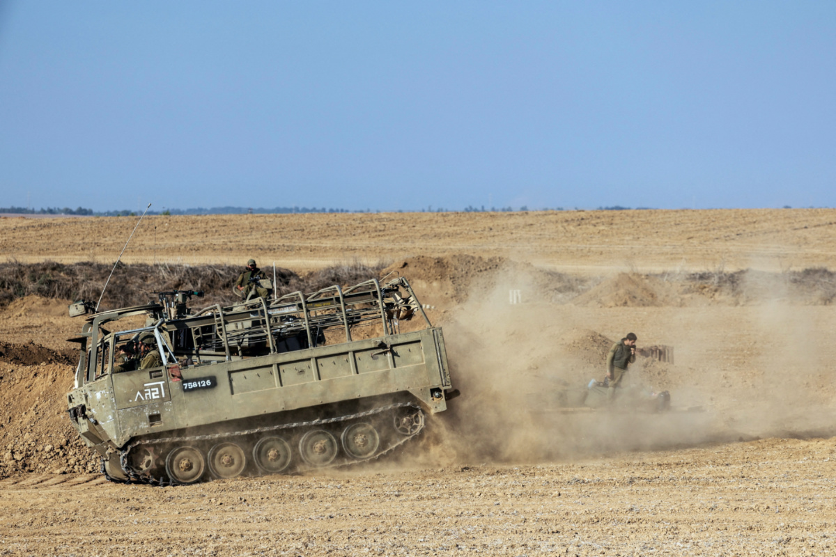 Israeli military vehicles and soldiers from an artillery unit gather near Israel's border with the Gaza Strip, in southern Israel, on 12th October, 2023.