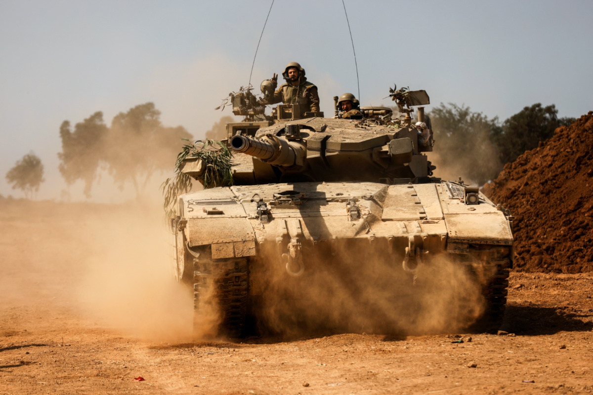 An Israeli tank takes position near Israel's border with the Gaza Strip, in southern Israel, on 13th October, 2023