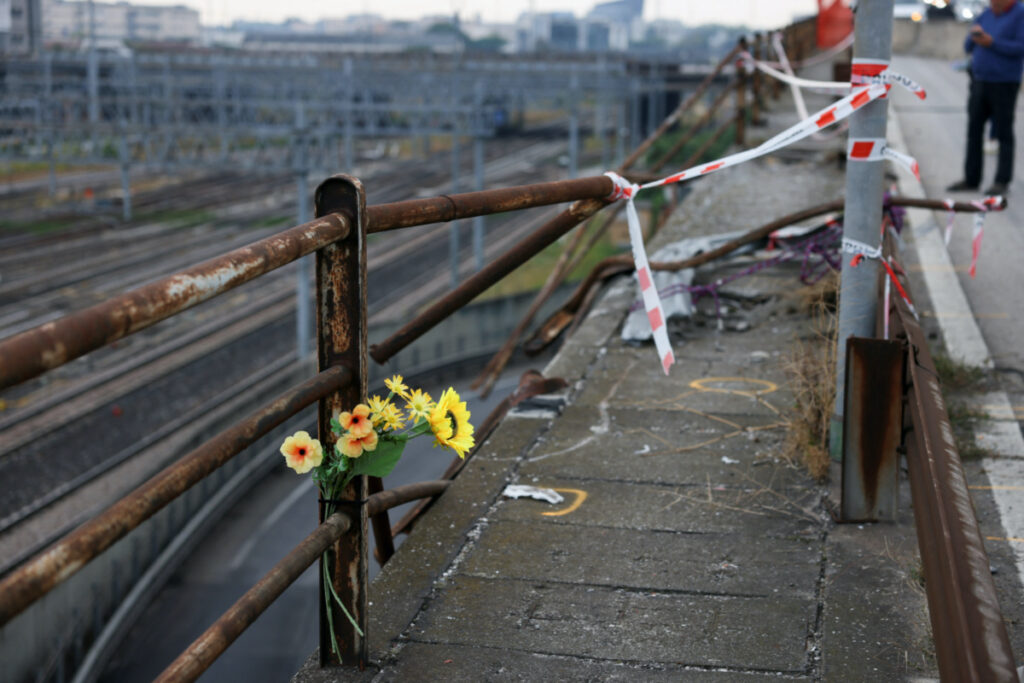 Flowers are seen at the site where a coach crashed off an overpass in Mestre, Italy, on 4th October, 2023