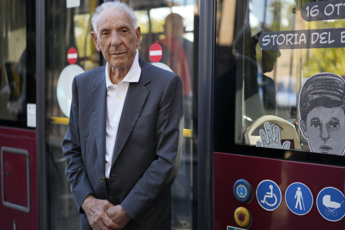 Emanuele Di Porto, 92, stands in front of a bus of the No 23 route during the inaugurating of a traveling exhibit recounting his story, in Rome, on Tuesday, 10th October, 2023