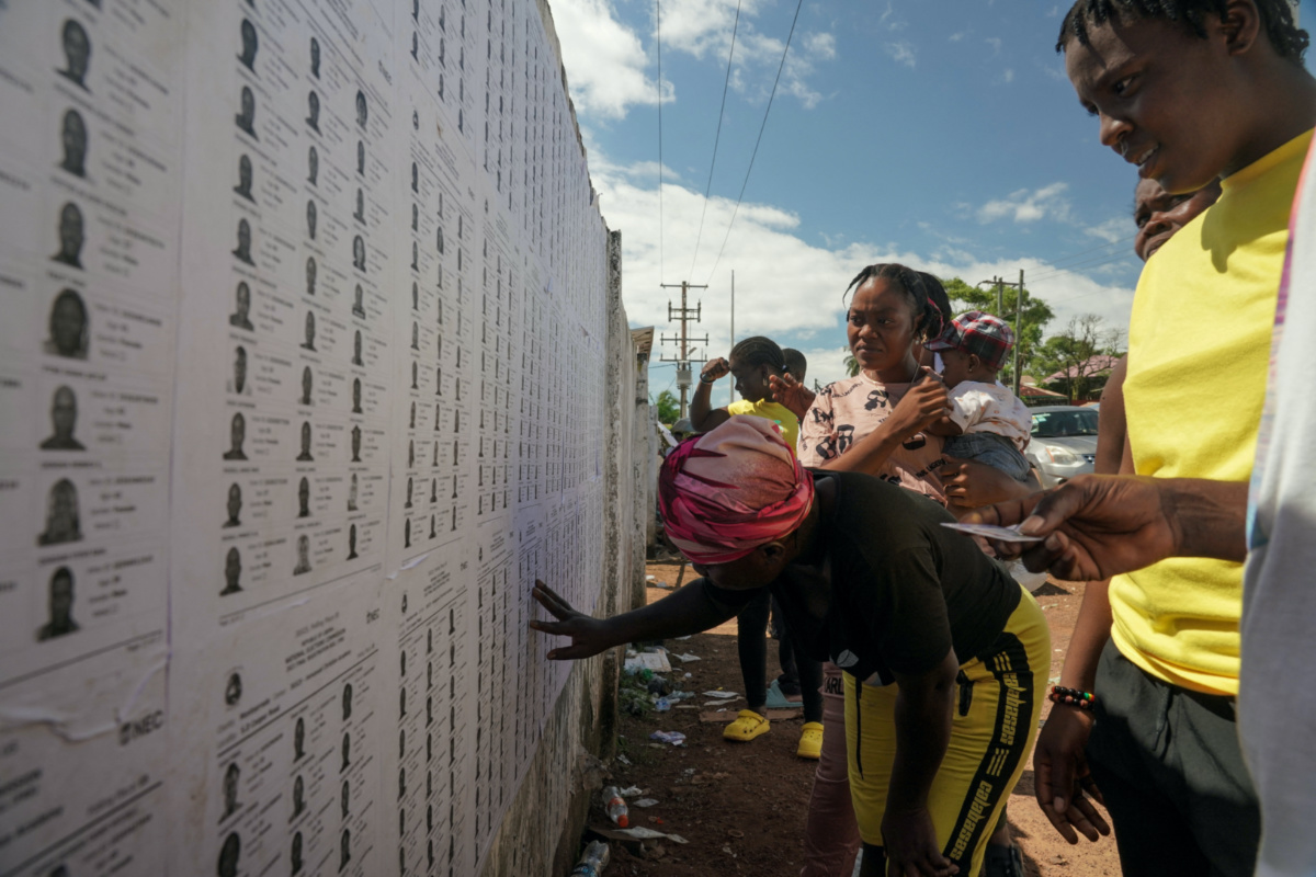 People search for their name on the list before they cast their votes during Liberia's presidential election in Monrovia, Liberia, on 10th October, 2023