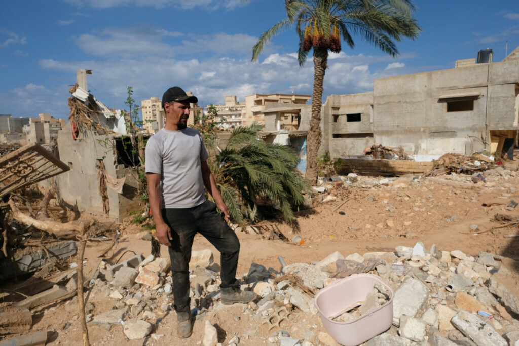 Abdul Salam Ibrahim Al-Qadi, 43-years-old, stands on the rubble in front of his house while searching for his father and brother who went missing after the deadly floods in Derna, Libya, on 28th September, 2023.