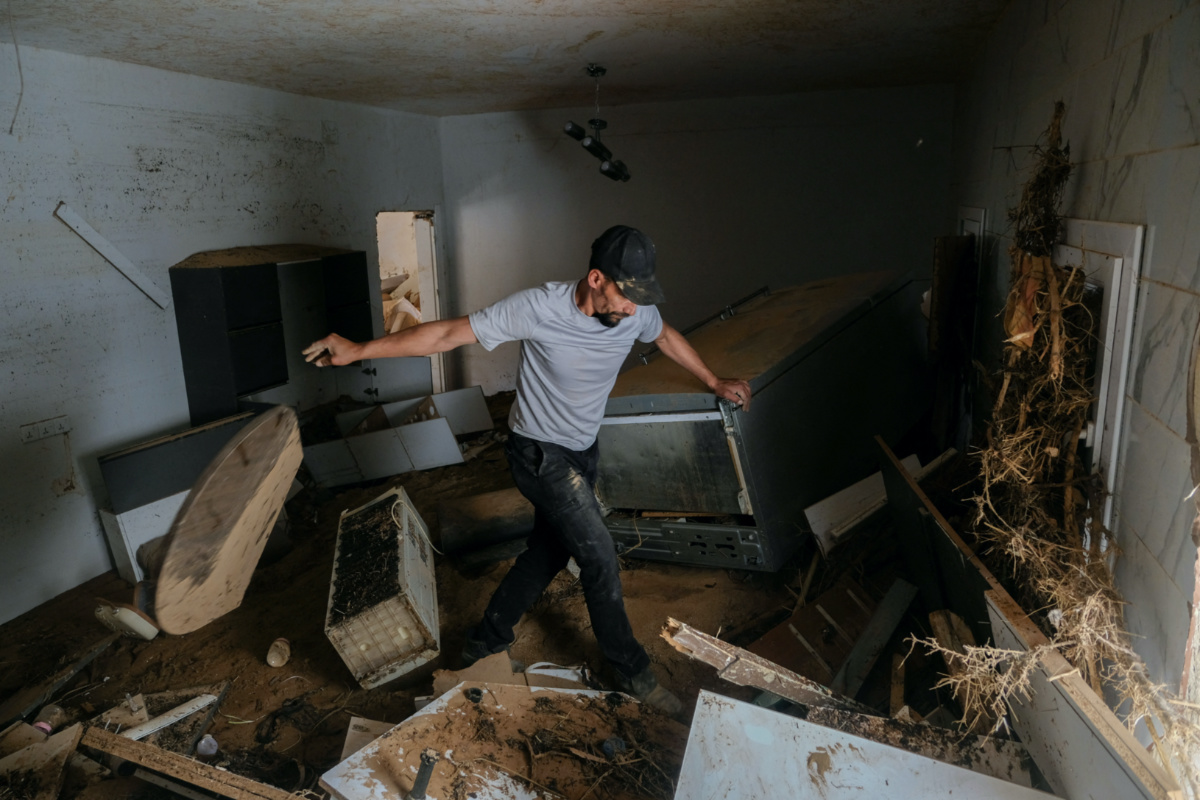 Abdul Salam Ibrahim Al-Qadi, 43-years-old, looks inside his home for his father and brother who are missing after the deadly floods in Derna, Libya, on 28th September, 2023. 
