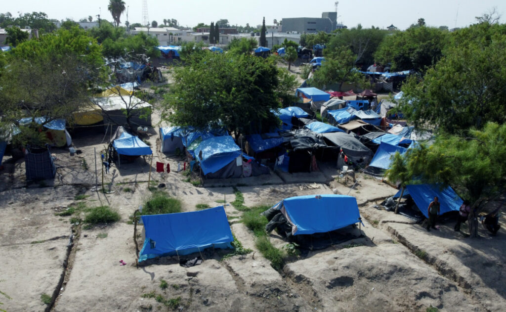 Asylum seekers wait at a makeshift camp to attempt to cross into the US, in Matamoros, Mexico, on 27th July, 2023